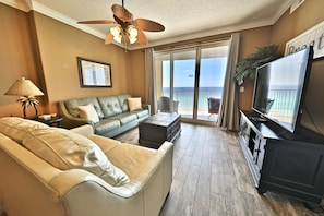 Gulf front living room with a large flatscreen TV.