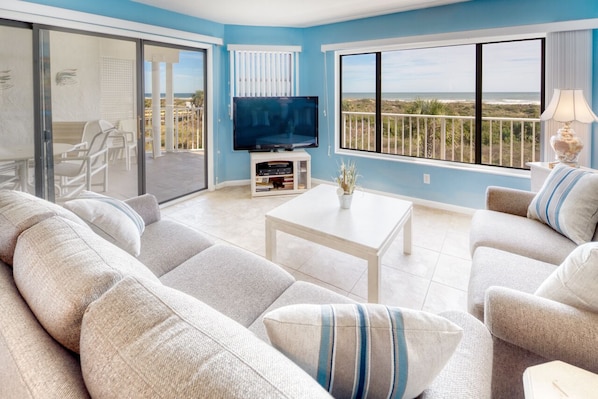 Living Room - Spacious living room with open floor plan and connected balcony featuring a direct view of the ocean.