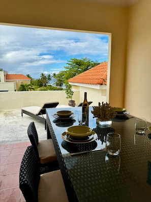 Third floor dining area looking out from overhang covered patio-seating for 8.