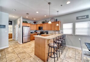 Spacious Kitchen with bar stools 