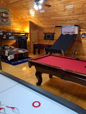 Air hockey Arcade basketball Foosball TV seating area Pool table