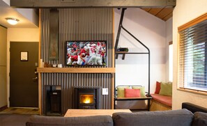 Living Room with 55" Smart TV and sleeper sofa.