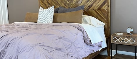 West Elm King sized bed with carved chevron headboard.