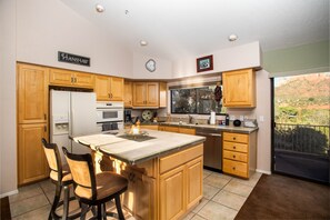 Open concept kitchen with access to wrap around deck with ample red rock views!