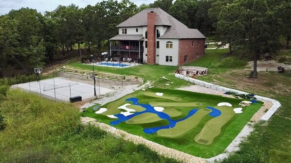 Complete w/ mini golf, pool, pickleball court, and fireplace!