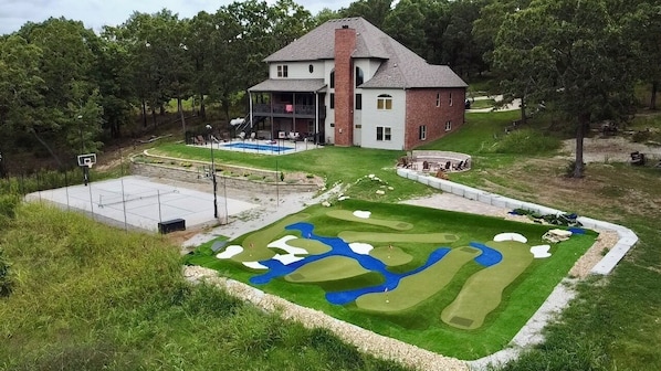 Complete w/ mini golf, pool, pickleball court, and fireplace!