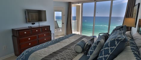 Master bedroom with breathtaking ocean views and private access to balcony.