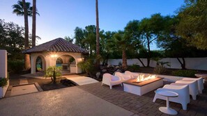 Cabana with built-in grill, seating around the fire feature