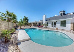 Private heated pool with lounge chairs
