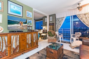 Living room with open sliding door looking toward bedroom