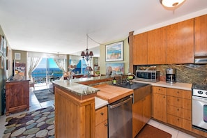 Custom Kitchen with stainless sink, cutting board and dishwasher
