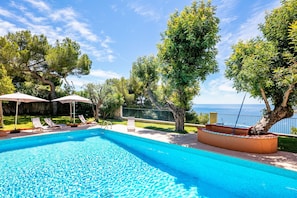Swimming pool in residence with garden and sea view
