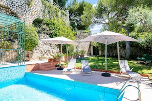 Swimming pool with garden furniture