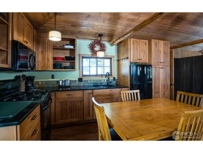 Updated kitchen with gas range.  The kitchen is well stocked.