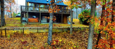 From rear of cabin with drone camera.  Large rear porch with views/hot tub.