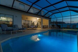 Nightime changing coloured light in pool.