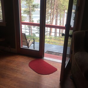 Double glass doors to the deck where a picnic table, 2 chairs, & BBQ. await you!