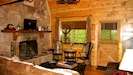 Open Living Room with picture window, game table & real wood burning fireplace