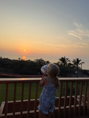 Guest w/concho shell at the end of day sunset traditiion, then end of vacation