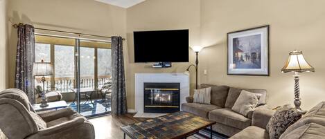 Bright & Clean Living Room has electric fireplace and views of the lake. 