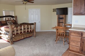View from entry door. Queen Aspen bed, walk in  closet, 34' TV, Table for two