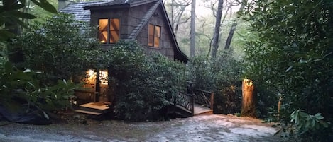 Your cozy,  bark-covered cottage in the woods awaits...step inside...