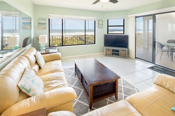 Living Room - Spacious living room with open floor plan and connected balcony featuring a direct view of the ocean.