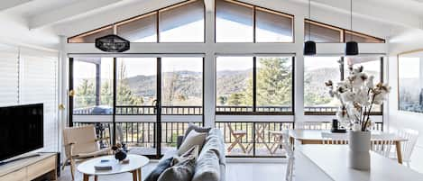 Lounge room at Eliza Lee one, with a view out towards Lake Jindabyne.