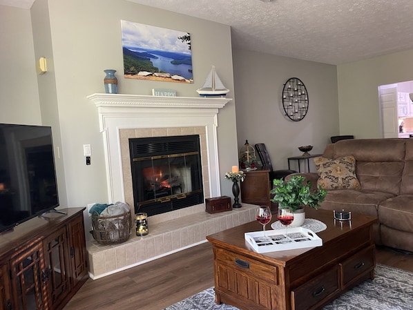 Enjoy glass of wine in evening by the fireplace