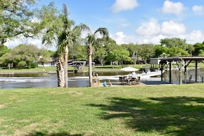 View of the creek and private dock from back porch.  Huge backyard!