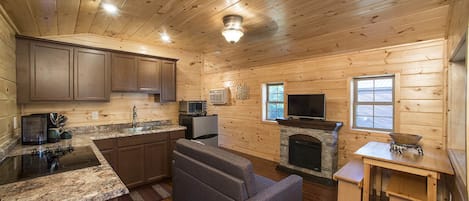 Great room showing fireplace and kitchen
