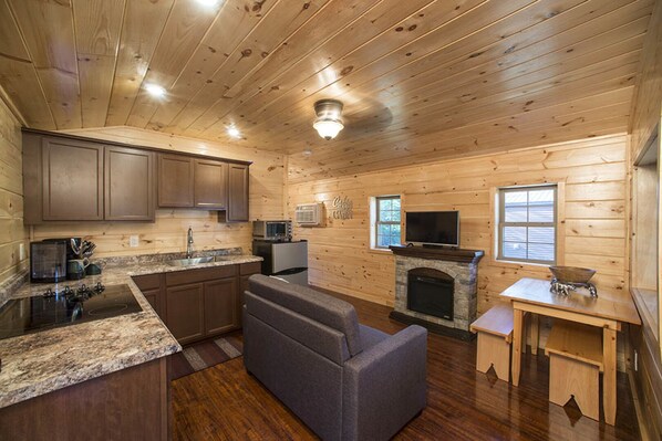 Great room showing fireplace and kitchen
