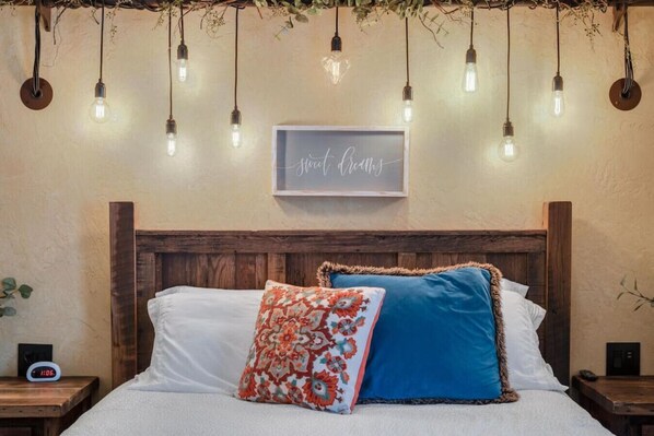 The Rustic Suite is unique and distinctly appointed with furniture fashioned by local craftsmen from reclaimed barn timbers. Shown here is the queen bed in the private bedroom.