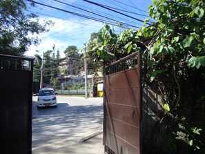 Access to property gate from M. Roxas Street. Road curve is wide and is lighted 