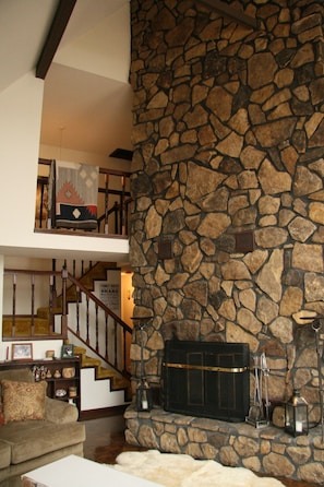 Living room with fireplace. Master suite is upstairs.