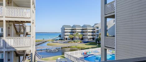 Enjoy a view of both the bay and the pool from the back deck