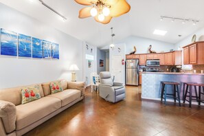 Open concept living, dining, and kitchen area with new sofa and accent chair