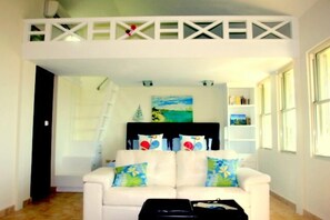 Main living area with a king size bed and a loft