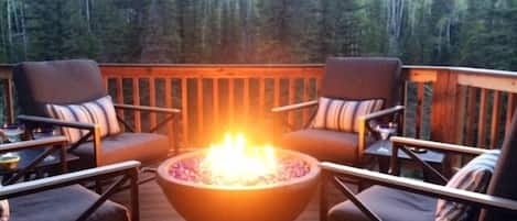 Inviting Fire Pit to warm you on cool evenings while you relax in comfy rockers