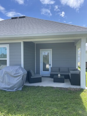 Back porch with sectional outdoor sofa and new propane grill 