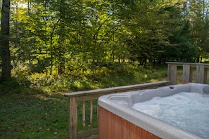 Enjoy the view of the stream while soaking in the hot tub