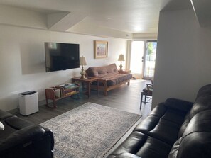 Living Room with Large Screen TV, Leather Reclining couches and Queen Futon