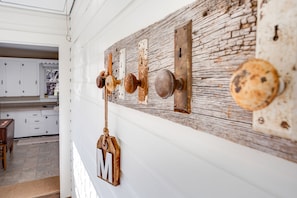 Coat rack built by Allen using our reclaimed barn wood and antique door knobs. 