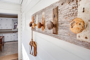 Coat rack built by Allen using our reclaimed barn wood and antique door knobs.