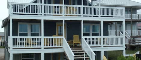 Photo shows lower left back patio accommodation. Patio view backyard and dunes