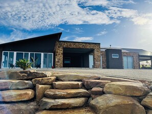 Front facade - home & retaining walls built using extracted paddock stone