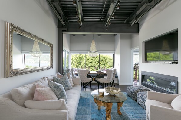 Spacious living room with soaring steel beam ceilings