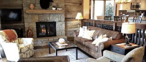 The living room offers a modern mountain  atmosphere with reclaimed wood accents