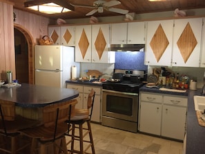 Kitchen with dishwasher, gas stove, refrigerator, and great cookware. 