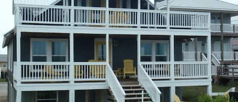 2nd floor back deck. Stairs lead up to the large deck. Seating for up to ten.